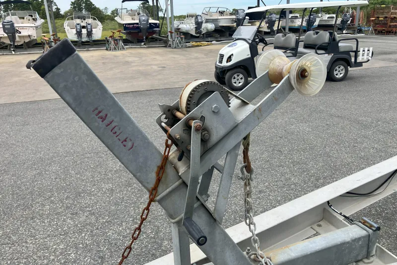 Slide: The Image of Boat trailer winch in a marina with parked boats and golf cart. - 45