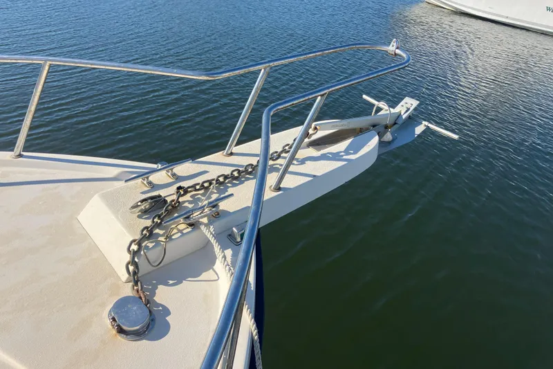 Slide: The Image of Bow of 2001 Parker 2520 Sport Cabin with anchor and chain on calm water. - 9