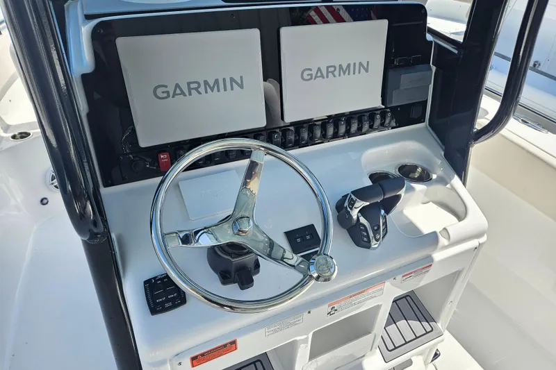 Slide: The Image of 2026 Sea Hunt Ultra 265 SE dashboard with Garmin displays and steering wheel. - 14