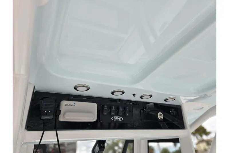 Slide: The Image of 2026 Sea Hunt Ultra 265 SE console with Garmin electronics and control panel. - 15