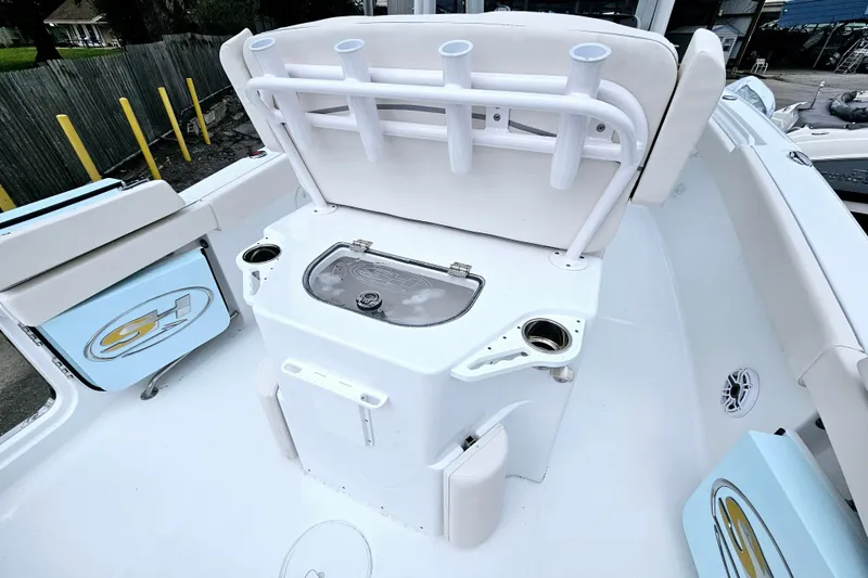 Slide: The Image of Sea Hunt Ultra 265 SE 2026 boat interior with rod holders and storage compartments. - 16