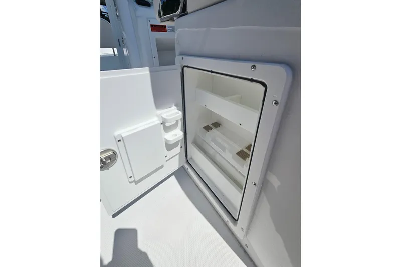 Slide: The Image of Open storage compartment on 2026 Sea Hunt Ultra 265 SE boat. - 17