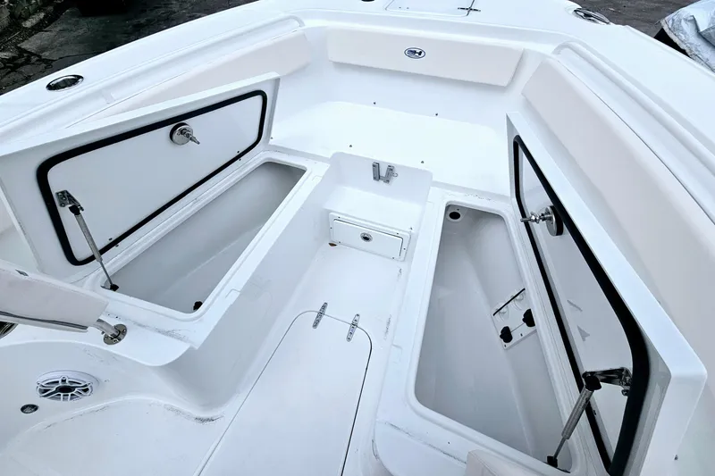 Slide: The Image of 2026 Sea Hunt Ultra 265 SE boat interior with open storage compartments. - 21