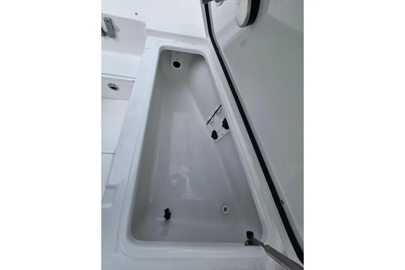 Slide: The Image of 2026 Sea Hunt Ultra 265 SE boat storage compartment, open and empty. - 22