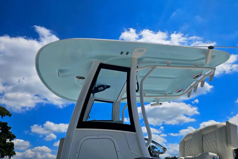 Slide: The Image of 2026 Sea Hunt Ultra 265 SE boat against a bright blue sky with clouds. - 3