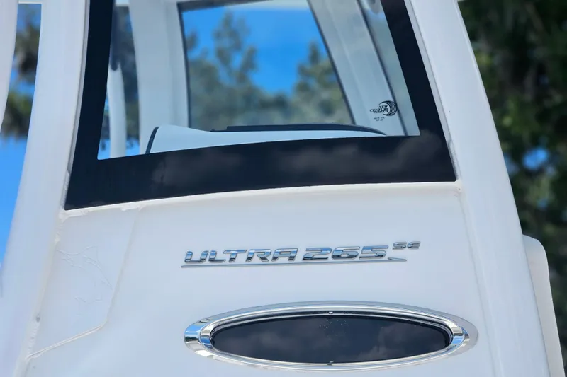 Slide: The Image of 2026 Sea Hunt Ultra 265 SE boat, close-up of model name on white exterior. - 6