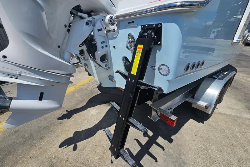 Slide: The Image of 2026 Sea Hunt Ultra 265 SE boat trailer with motor and ladder detail. - 8