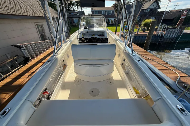 Slide: The Image of 1995 Wellcraft Scarab Sport 302 boat interior, docked, with steering console and seating. - 11