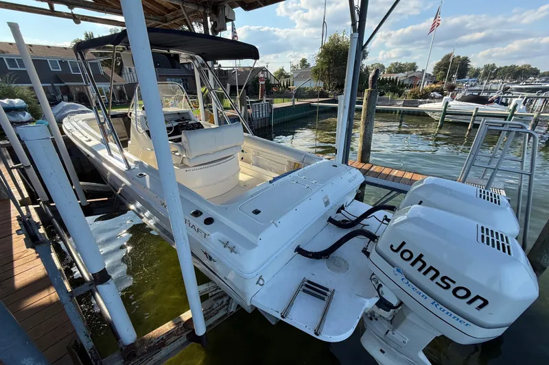Slide: The Image of 1995 Wellcraft Scarab Sport 302 boat with Johnson engines docked at marina. - 12