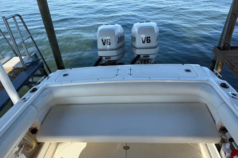 Slide: The Image of 1995 Wellcraft Scarab Sport 302 boat with dual Johnson V6 engines at dock. - 13