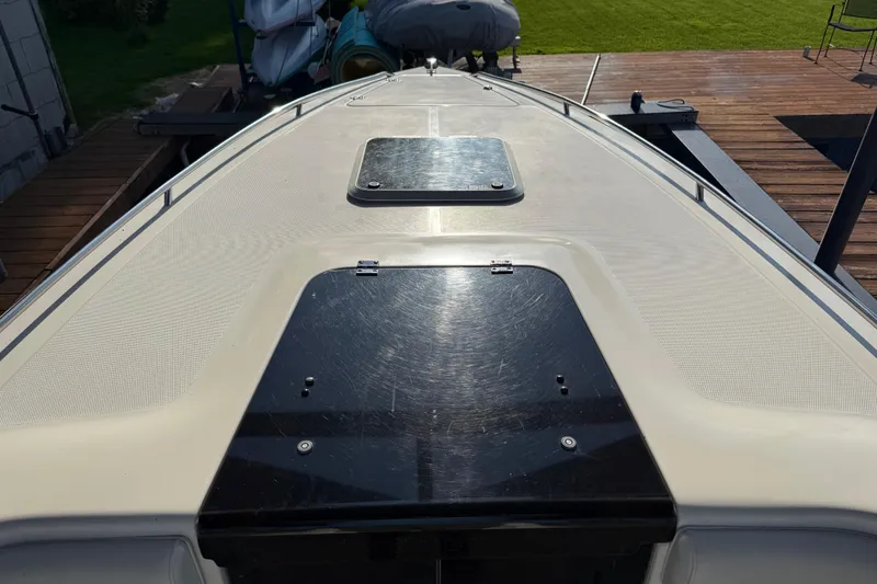 Slide: The Image of 1995 Wellcraft Scarab Sport 302 boat deck with hatch, docked on wooden platform. - 18