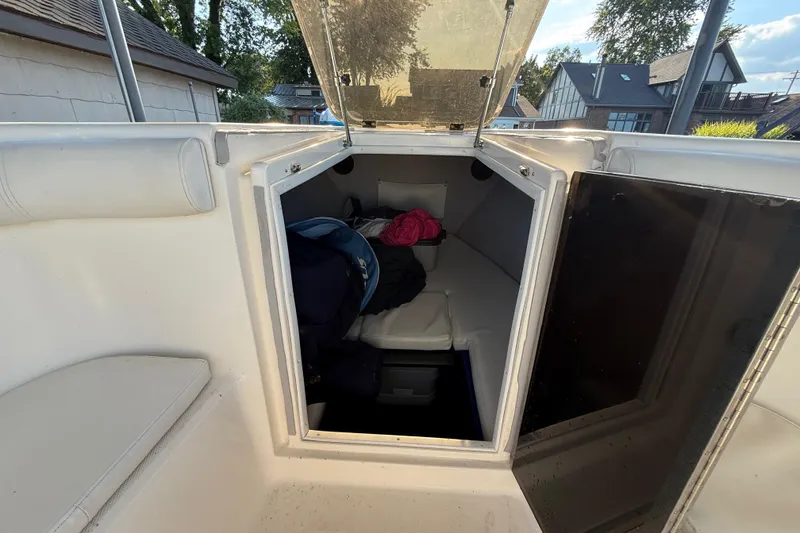 Slide: The Image of 1995 Wellcraft Scarab Sport 302 cabin interior with seating and storage. - 20