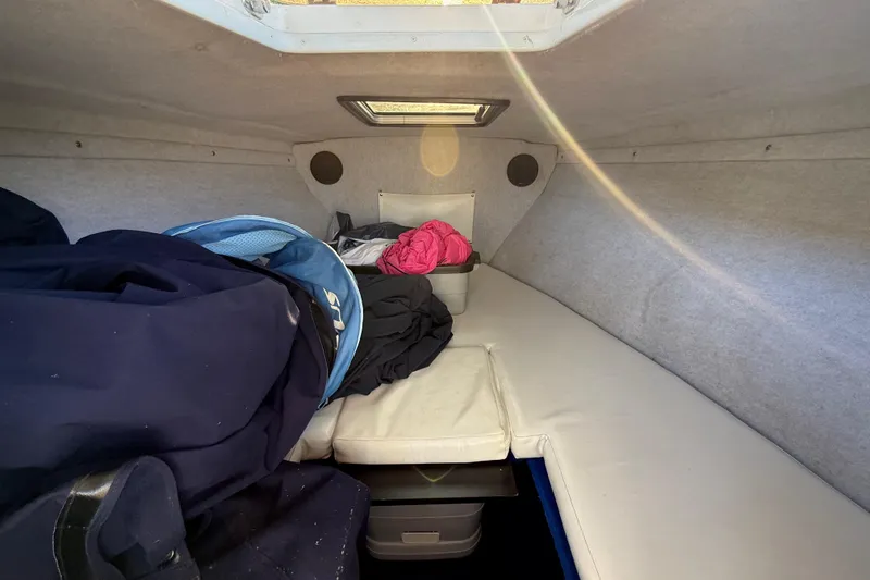 Slide: The Image of Interior cabin of 1995 Wellcraft Scarab Sport 302 boat with cushions and storage. - 21