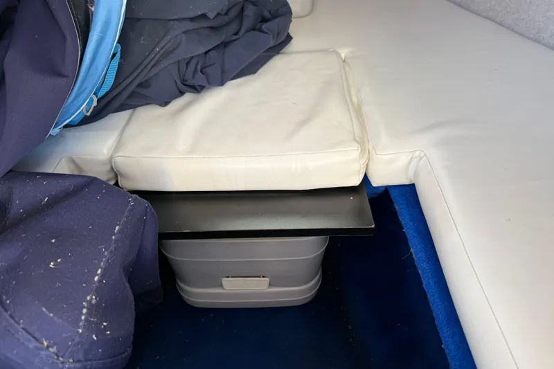 Slide: The Image of Interior of 1995 Wellcraft Scarab Sport 302 boat with white seating and storage. - 22