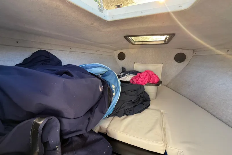 Slide: The Image of Interior cabin of 1995 Wellcraft Scarab Sport 302 with clothes and storage. - 23