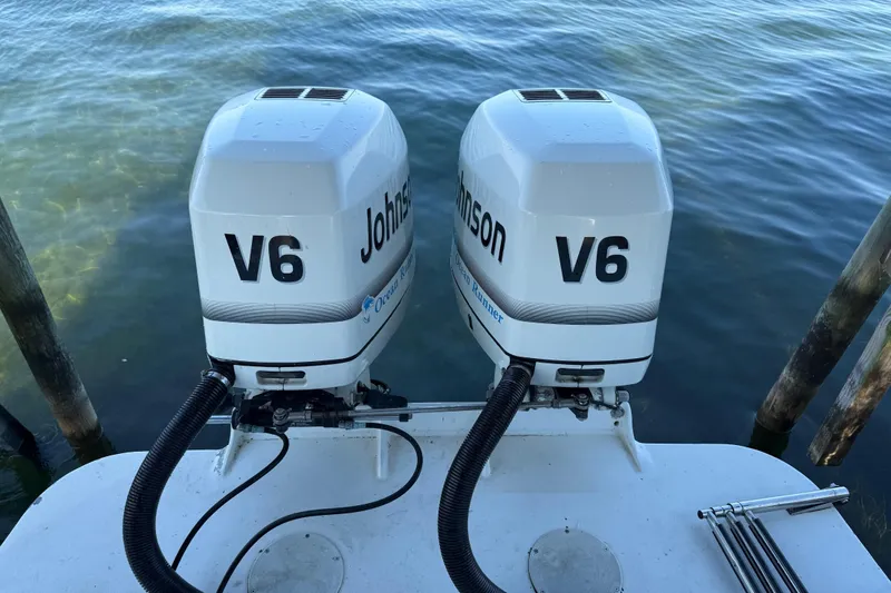 Slide: The Image of Twin Johnson V6 outboard engines on a 1995 Wellcraft Scarab Sport 302 boat. - 24