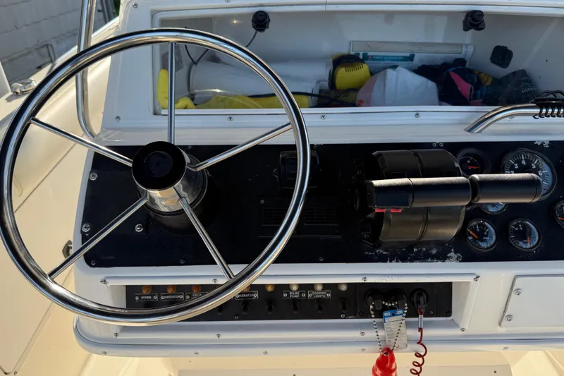 Slide: The Image of 1995 Wellcraft Scarab Sport 302 boat dashboard with steering wheel and control panel. - 26