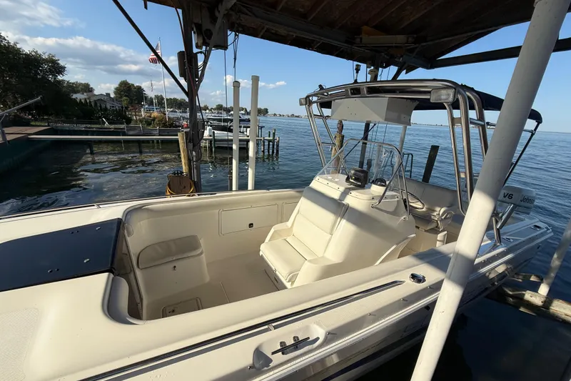 Slide: The Image of 1995 Wellcraft Scarab Sport 302 boat docked by a scenic waterfront. - 4