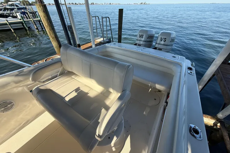 Slide: The Image of 1995 Wellcraft Scarab Sport 302 boat with dual V6 Johnson engines docked by the water. - 7