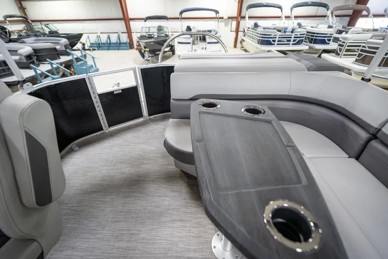 Slide: The Image of 2021 Bennington 21 SLX pontoon boat interior with gray seating and table. - 18