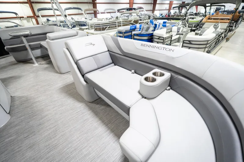 Slide: The Image of 2021 Bennington 21 SLX pontoon boat interior with gray seating and cup holders. - 22