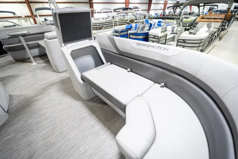 Slide: The Image of 2021 Bennington 21 SLX pontoon boat interior with gray seating in showroom. - 24