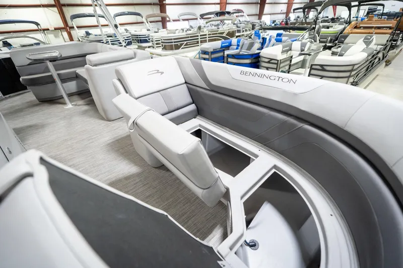 Slide: The Image of 2021 Bennington 21 SLX pontoon boat interior with gray seating and storage compartment. - 25