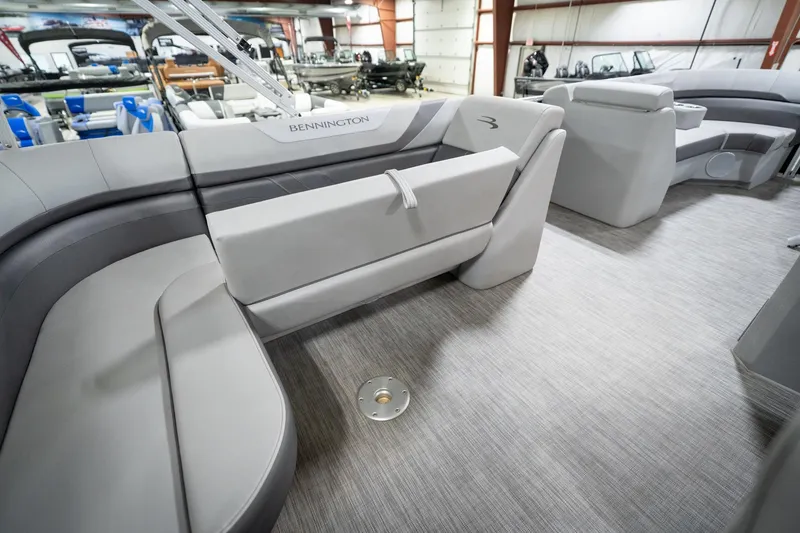 Slide: The Image of 2021 Bennington 21 SLX pontoon boat interior with gray seating and storage compartments. - 32