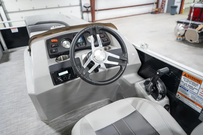 Slide: The Image of 2021 Bennington 21 SLX boat interior with steering wheel and dashboard controls. - 34