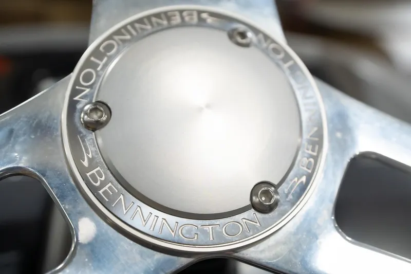 Slide: The Image of 2021 Bennington 21 SLX boat dashboard with steering wheel and control panel in showroom. - 35