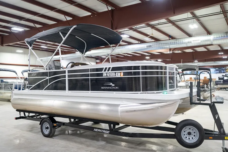 Slide: The Image of 2021 Bennington 21 SLX pontoon boat in indoor showroom, front view. - 6