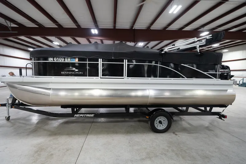 Slide: The Image of Trailer wheel of a 2021 Bennington 21 SLX pontoon boat in a showroom. - 62