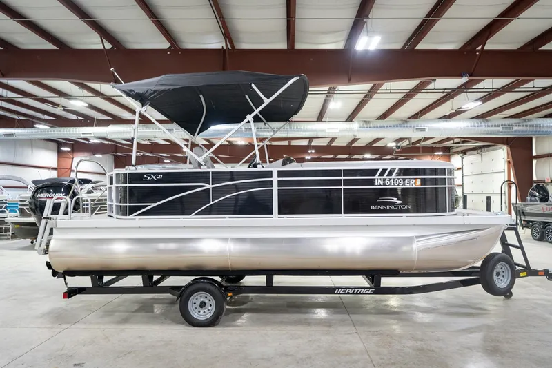 Slide: The Image of 2021 Bennington 21 SLX pontoon boat on trailer in indoor showroom. - 7