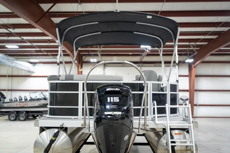 Slide: The Image of 2021 Bennington 21 SLX pontoon boat with Mercury engine in indoor showroom. - 9