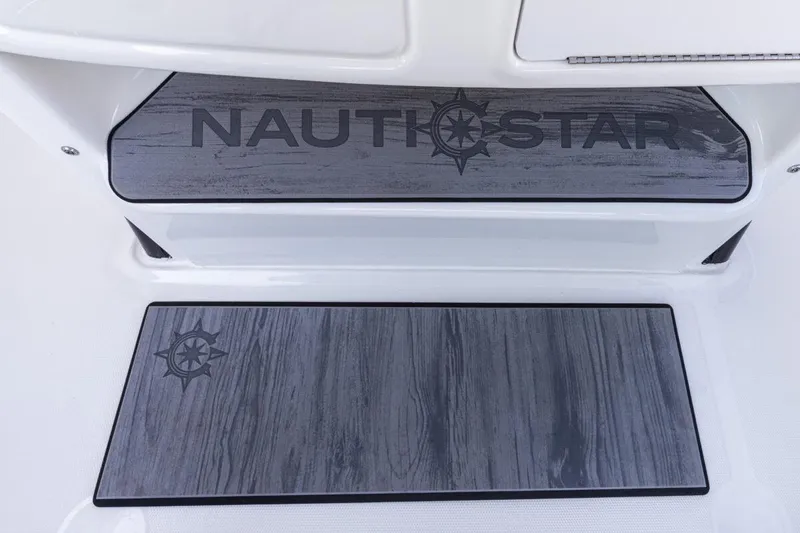 Slide: The Image of 2026 NauticStar 251 Hybrid boat deck with logo and wood-textured flooring. - 10