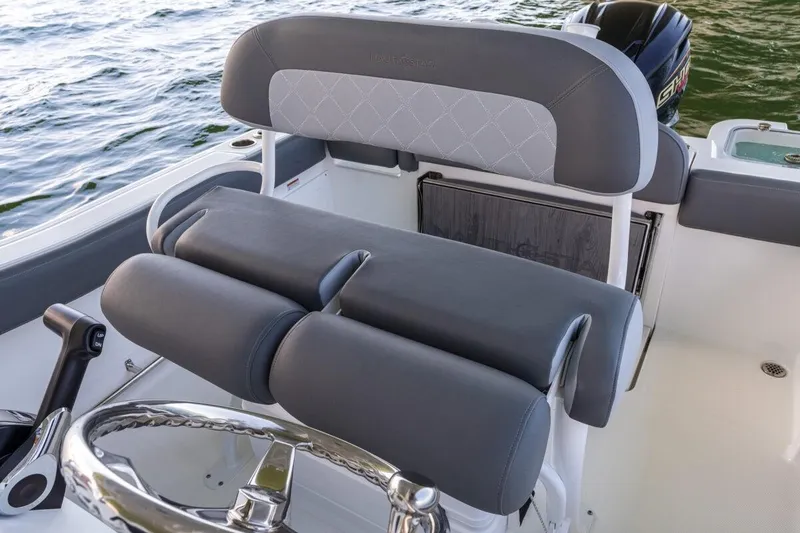 Slide: The Image of 2026 NauticStar 251 Hybrid boat interior with sleek seating and steering wheel. - 12
