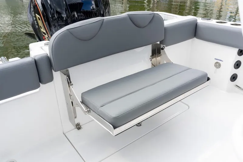 Slide: The Image of 2026 NauticStar 251 Hybrid boat with gray cushioned seating and sleek design. - 3