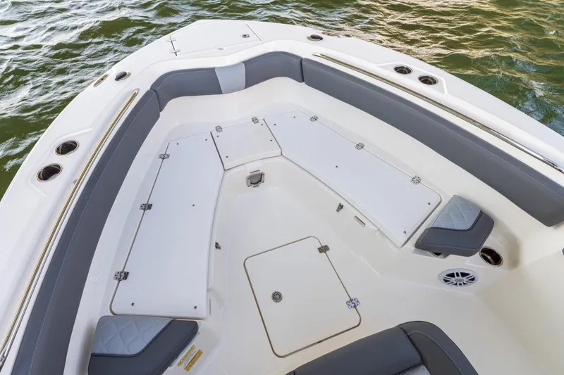 Slide: The Image of 2026 NauticStar 251 Hybrid boat interior with cushioned seating and storage compartments. - 6