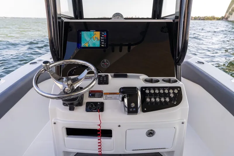 Slide: The Image of 2026 NauticStar 251 Hybrid boat dashboard with steering wheel and navigation system. - 9