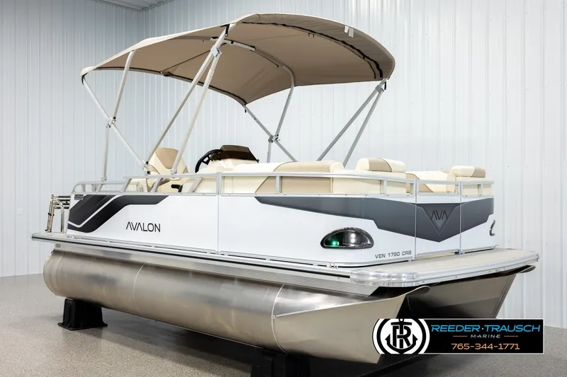 Slide: The Image of 2026 Avalon VEN CRB pontoon boat with canopy in showroom display. - 3