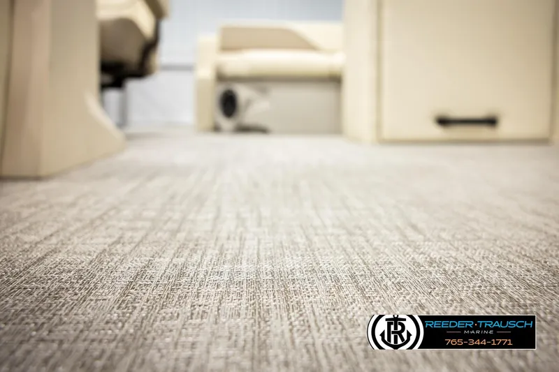 Slide: The Image of Carpeted interior of 2026 Avalon VEN CRB boat, featuring beige seating and flooring. - 42