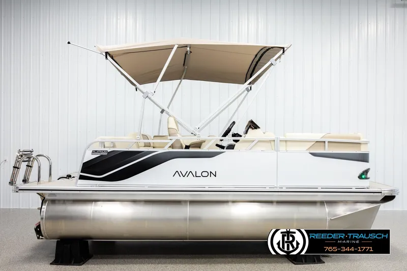 Slide: The Image of 2026 Avalon VEN CRB pontoon boat with canopy, displayed indoors. - 5