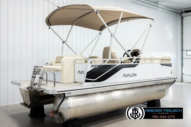 Slide: The Image of 2026 Avalon VEN CRB pontoon boat with canopy in showroom setting. - 6