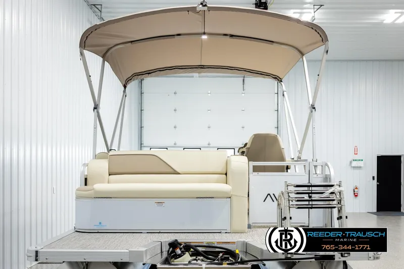 Slide: The Image of 2026 Avalon VEN CRB pontoon boat with canopy in a showroom. - 7
