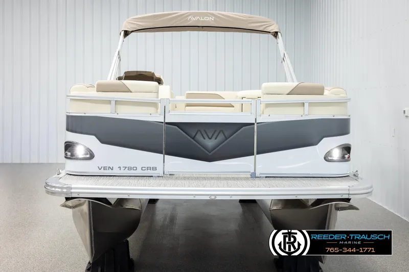 Slide: The Image of 2026 Avalon VEN CRB pontoon boat with beige seating and canopy in showroom. - 8