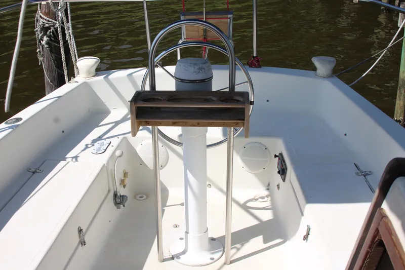 Slide: The Image of Cockpit of 1980 Watkins MONOHULL sailboat with steering wheel and wooden console. - 11