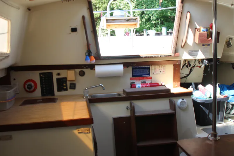 Slide: The Image of Interior of a 1980 Watkins MONOHULL sailboat with kitchen and storage area. - 13