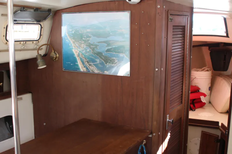 Slide: The Image of Interior of 1980 Watkins MONOHULL sailboat with wooden paneling and nautical decor. - 18