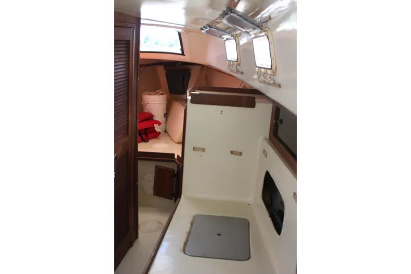 Slide: The Image of Interior of 1980 Watkins MONOHULL sailboat, featuring compact cabin space and storage. - 19