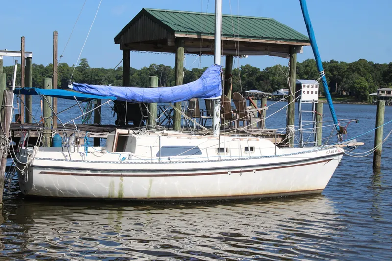 Slide: The Image of 1980 Watkins MONOHULL sailboat docked by a wooden pier on a sunny day. - 20